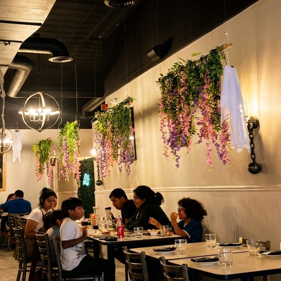 Restaurant interior with diners, hanging wisteria, and Halloween decorations including skeletons and ghosts.