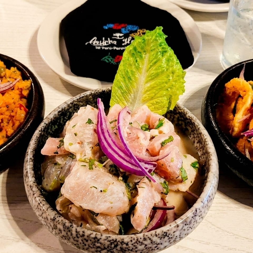Three bowls of Peruvian dishes: arroz con mariscos, ceviche, and fried calamari with red onions.