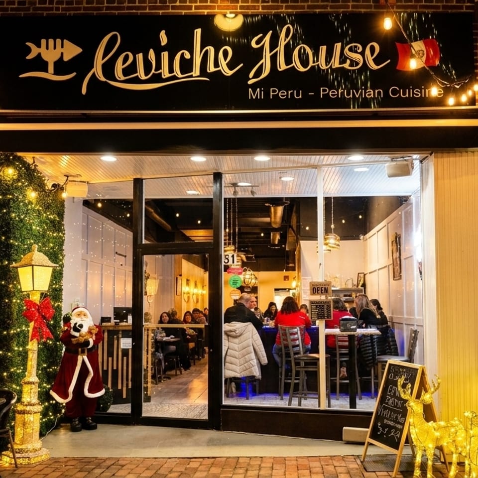 Exterior of Ceviche House restaurant at night, decorated with festive lights and a Santa statue.